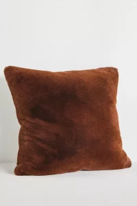 A close-up of the Sophie Faux Fur Pillow in black. A soft, cozy, and top rated Anthropologie home decor gift to add texture to a sofa.