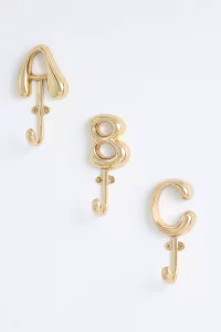 A gold wall hook featuring a Bubble Letter Monogram. A personalized and top rated Anthropologie gift for the home entryway or bathroom.