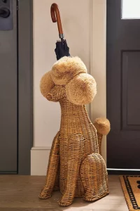 A playful Poodle Dog Woven Wicker Basket used for storage or home organization. One of the unique, top rated Anthropologie gifts for a dog lover.