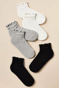 A set of white Athletic Ruffle Socks with delicate ruffles around the ankle. A trendy and affordable top rated Anthropologie accessory gift.