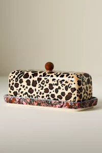 A colorful, handpainted Jylin Stoneware Butter Dish with a unique floral and leopard print pattern. A fun, top rated Anthropologie kitchenware piece.